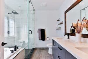 a remodeled bathroom with stylish walk-in shower and shower doors